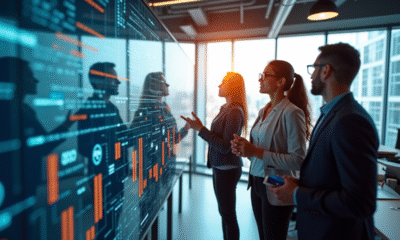 Groupe d'ingénieurs discutant de visualisations de données dans un bureau moderne